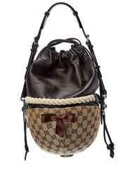 Designer handbag with brown leather top and patterned base on a white background