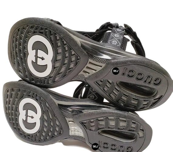 Black and gray sandals with brand logo on a white background