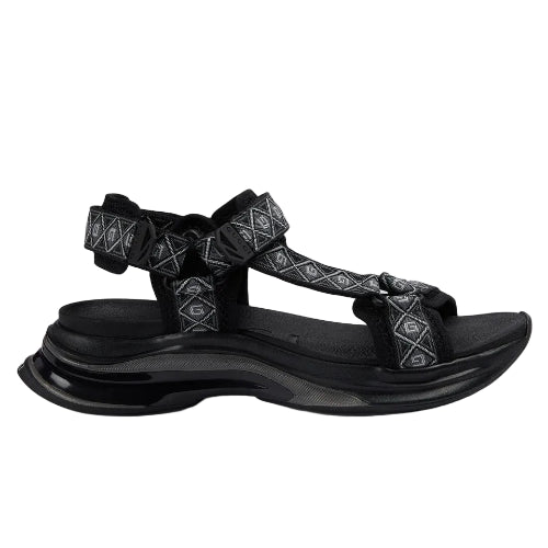 Black sandal with patterned straps on a light gray background