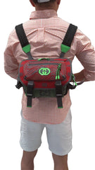 Person wearing a red backpack with green accents on a black background