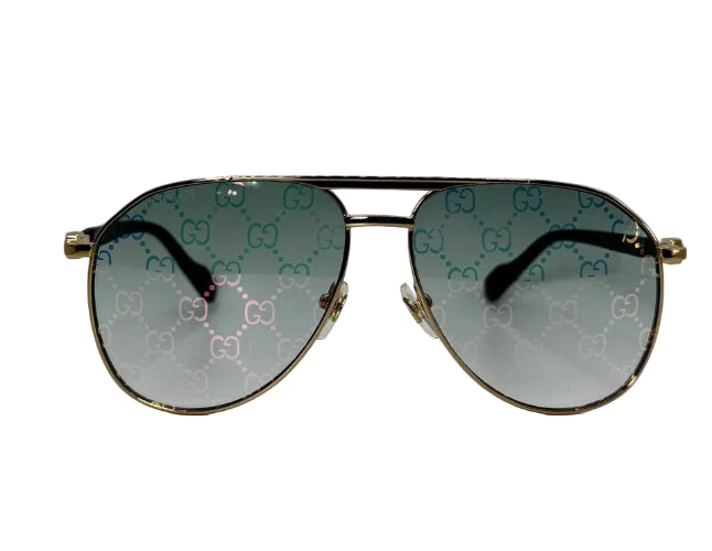 Aviator sunglasses with gold frame and patterned lenses on a white background