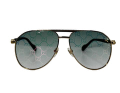 Aviator sunglasses with gold frame and patterned lenses on a white background