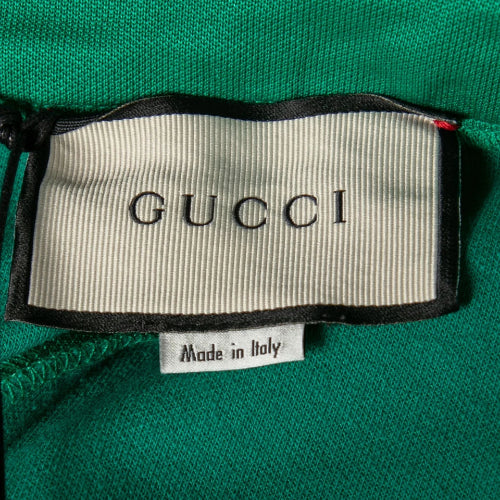 Gucci label on a green fabric background