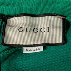 Gucci label on a green fabric background