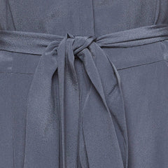 Close-up of a slate blue-gray belted garment, showing the fabric texture and tie detail.