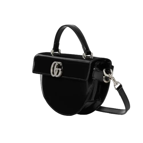 Black handbag with a brand logo on a light gray background