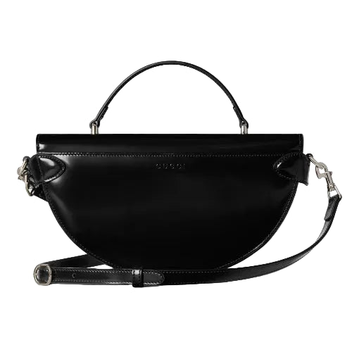 Black handbag with a strap on a white background