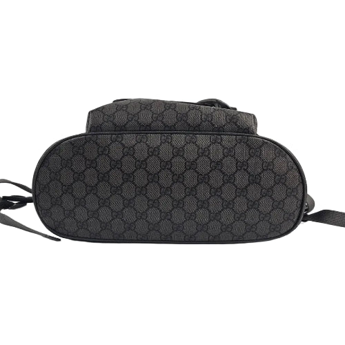 Black patterned handbag on a light gray background