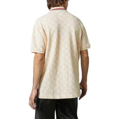 Person wearing a beige patterned shirt on a white background