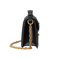 Black handbag with a gold chain on a white background