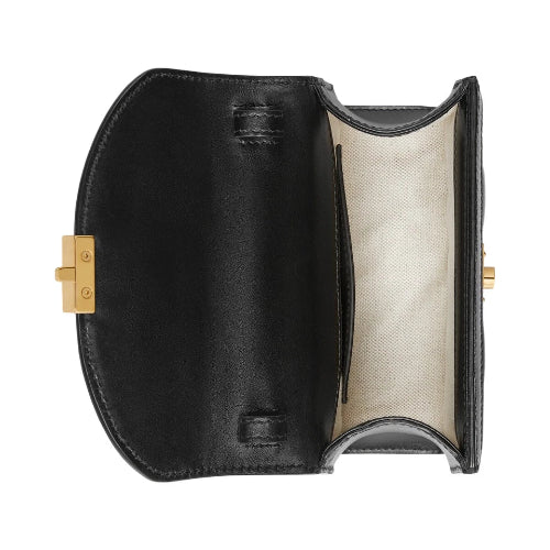 Black leather clutch with gold clasp on a white background