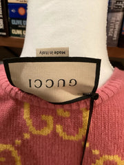 Close-up of a Gucci label on a garment with books in the background
