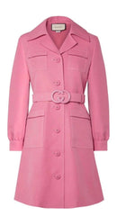 Pink coat with a belt and Gucci logo on a white background