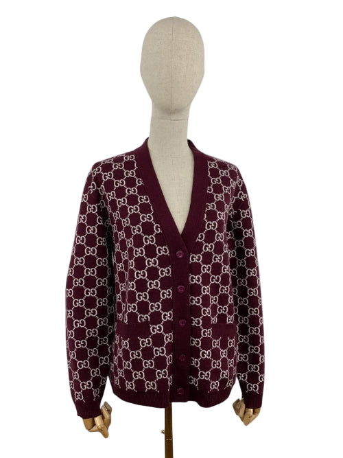 Maroon cardigan with white pattern on a mannequin against a white background