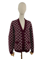 Maroon cardigan with white pattern on a mannequin against a white background