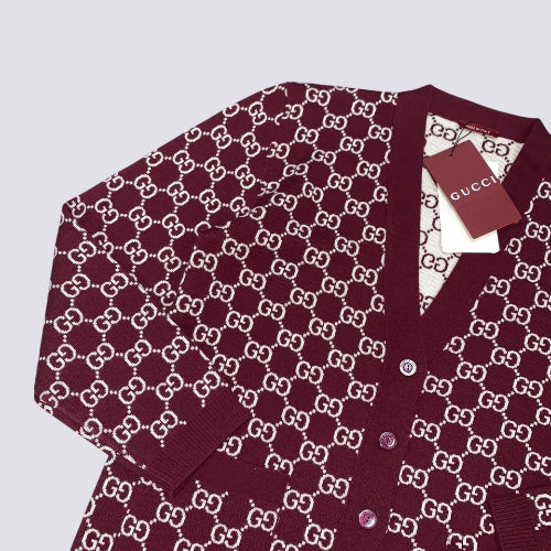 Maroon cardigan with white pattern on a light gray background