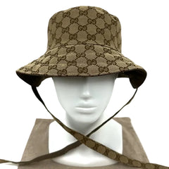 Beige bucket hat with brown pattern on a mannequin head against a light gray background