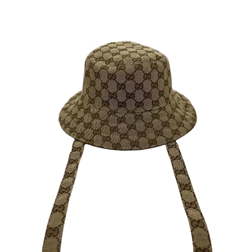Beige bucket hat with matching straps on a light gray background