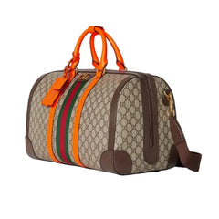 Designer handbag with orange handles and green and red stripes on a light gray background