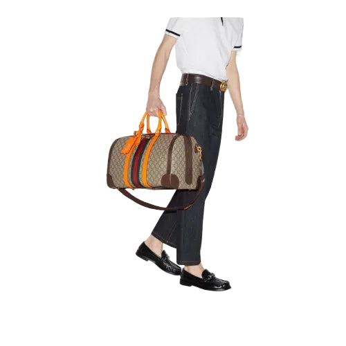 Person holding a patterned handbag with colorful stripes on a white background