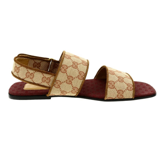 Brown sandal with Gucci logo on a white background