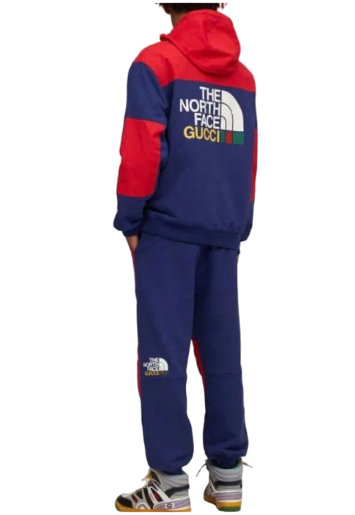 Child's outfit with a red and white jacket and matching pants on a plain background