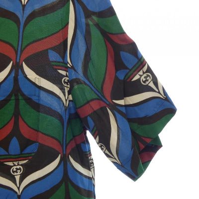 Colorful patterned fabric with Gucci logo on a white background
