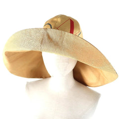 Beige wide-brimmed hat on a mannequin head against a white background