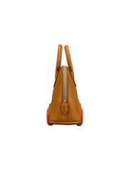 A tan leather handbag shown from the back, featuring a gold-tone zipper and bright orange-red outsole details, set against a neutral gray background.