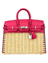 Pink handbag with wicker design on a white background