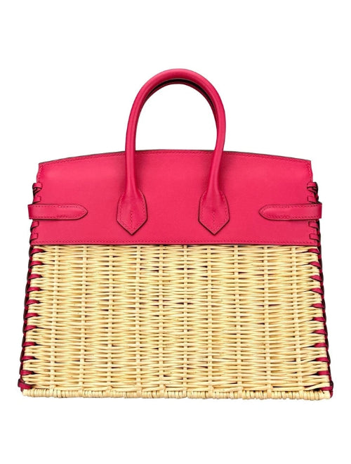 Pink handbag with wicker design on a white background