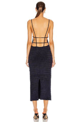 Woman wearing a black dress with thin straps on a white background