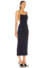 Woman wearing a dark blue textured dress on a white background