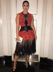 Woman wearing a red and black dress with a white background