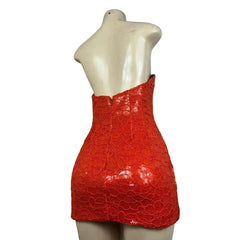 Red strapless dress on a mannequin against a white background