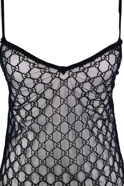 Black sheer mesh lingerie with an allover interlocking GG monogram pattern, thin shoulder straps, and a V-neckline, shown against a plain light background.