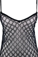 Black sheer mesh lingerie with an allover interlocking GG monogram pattern, thin shoulder straps, and a V-neckline, shown against a plain light background.