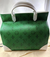 Green handbag with white accents on a light background