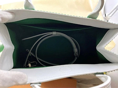 Close-up of a white electronic device with cables inside, on a light background