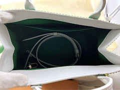 Close-up of a white electronic device with cables inside, on a light background