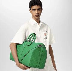 Person holding a green patterned bag against a white background