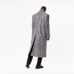 Man wearing a long floral coat on a white background