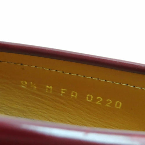 Close-up of a yellow leather surface with red stitching and text.