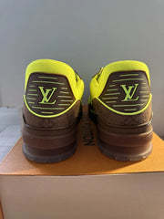 Louis Vuitton sneakers with brown and yellow accents on a box.