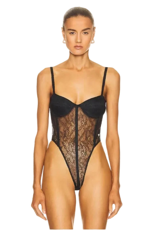 Model wearing a black lace bodysuit on a white background