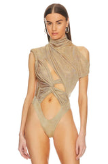 Woman wearing a gold swimsuit with cut-out design on a white background