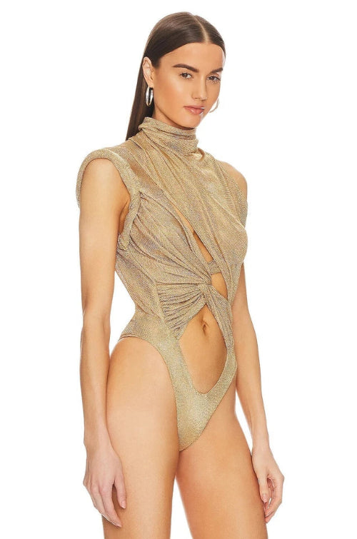 Woman wearing a beige mesh swimsuit on a white background