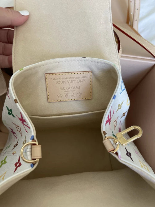 Louis Vuitton handbag with colorful interior pattern and visible brand logo.