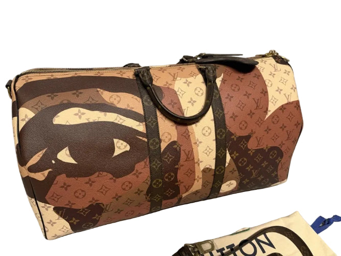 Designer handbag with monogram pattern on a gray floor