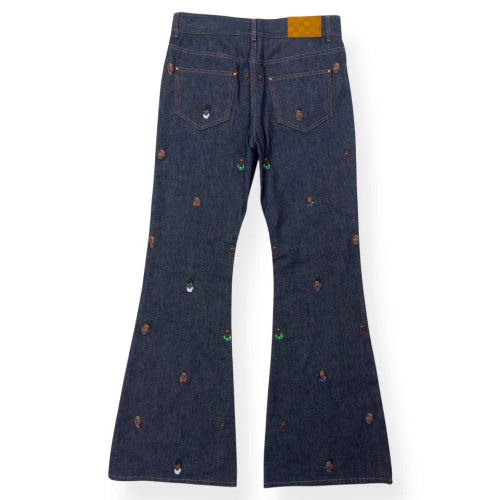 Dark blue jeans with decorative buttons on a white background